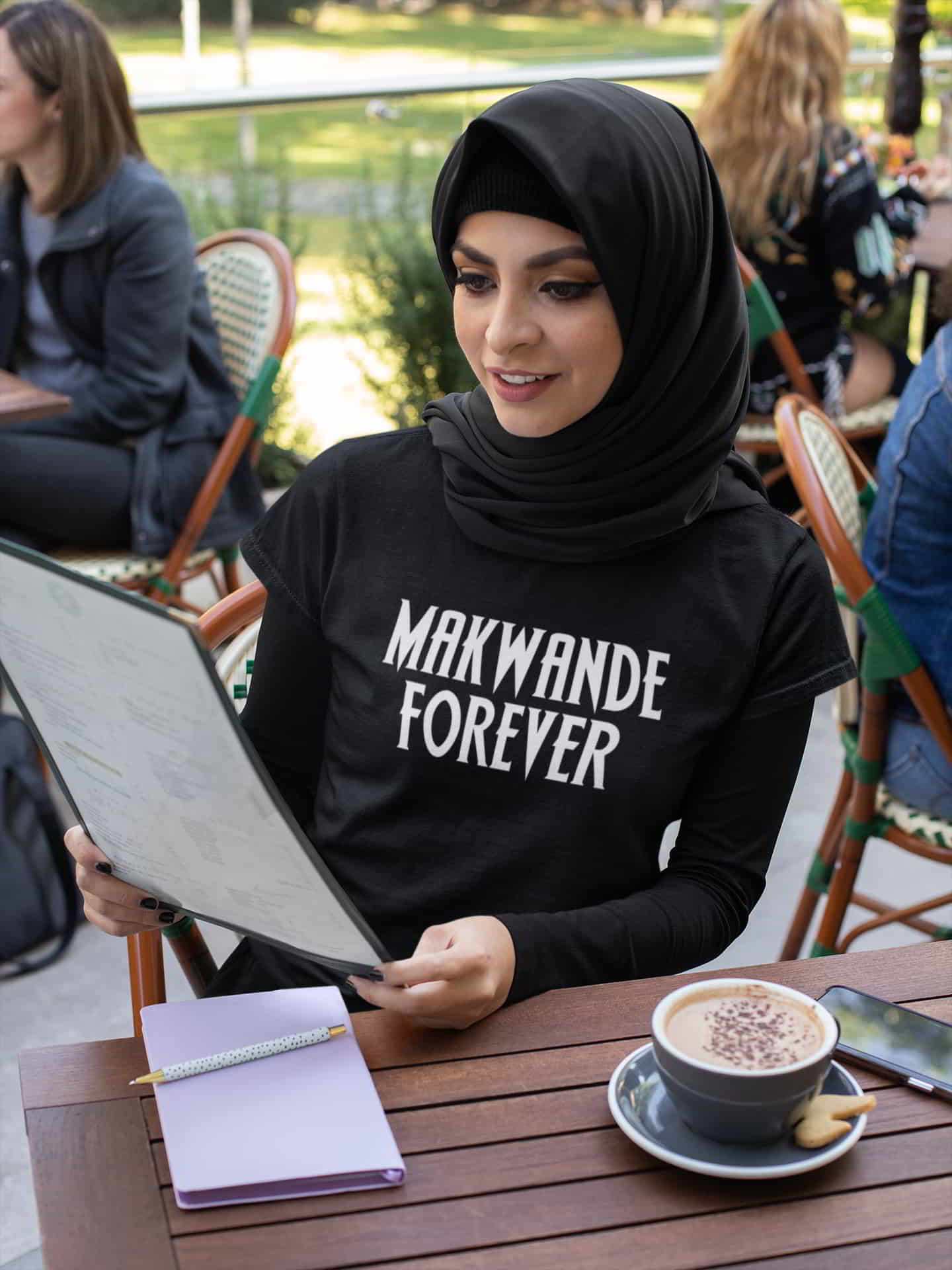 makwande prosperity forever black tshirt mockup woman black hijab ordering restaurant